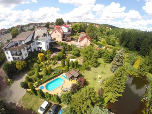 an aerial view of a house with a swimming pool at Pensjonat Willa Edyta in Mrągowo