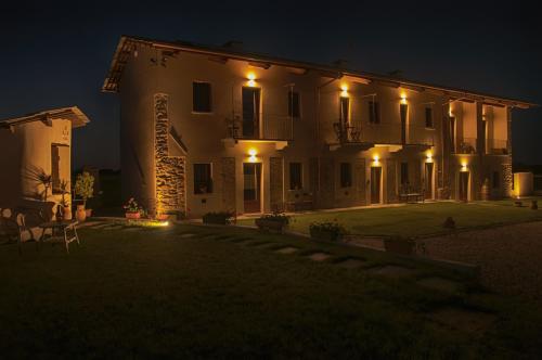 a large white house at night with lights at Amaranto Bed & Breakfast in Cavour