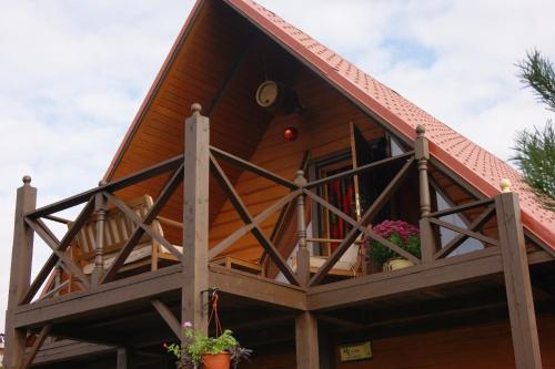 a house with a balcony with flowers on it at Traku Horizontai in Trakai