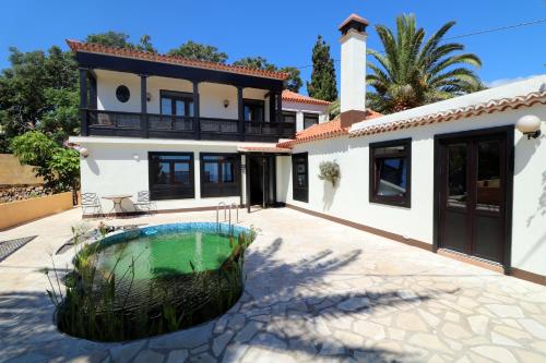 a house with a swimming pool in front of it at Villa Escondida in Breña Baja
