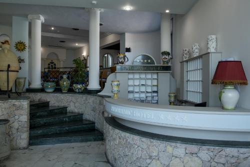 a store with stairs and a counter with vases at Hotel Panoramic in Giardini Naxos