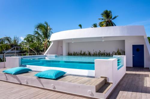 a villa with a swimming pool in the middle at Puerto Plaza Las Terrenas in Las Terrenas