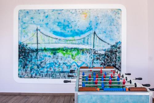a large painting of the golden gate bridge on a wall at Puerto Plaza Las Terrenas in Las Terrenas