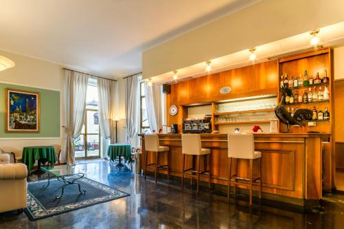 a bar in a living room with chairs around it at Hotel San Donato - Bologna centro in Bologna