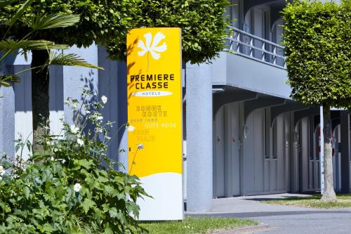 a yellow sign on the side of a building at Premiere Classe Lille Nord - Tourcoing in Tourcoing
