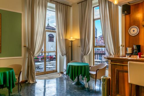 a room with a table and chairs and a window at Hotel San Donato - Bologna centro in Bologna