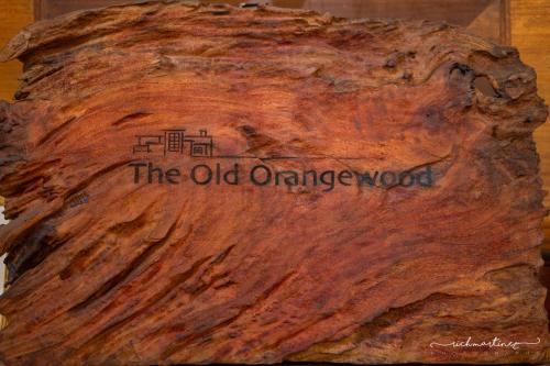 an old orange wood with a sign on it at Old Orangewood Bed & Breakfast in Baguio