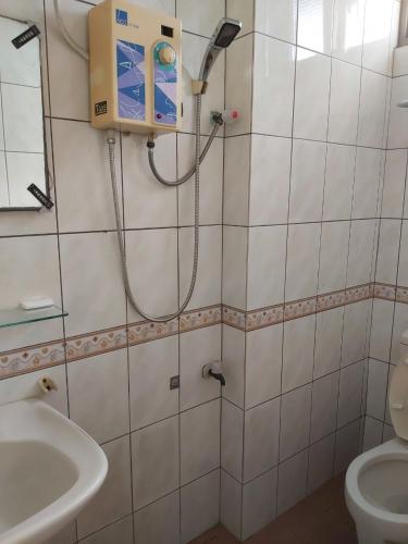 a bathroom with a shower and a toilet and a sink at Lanzhou 4th St in Chiayi City
