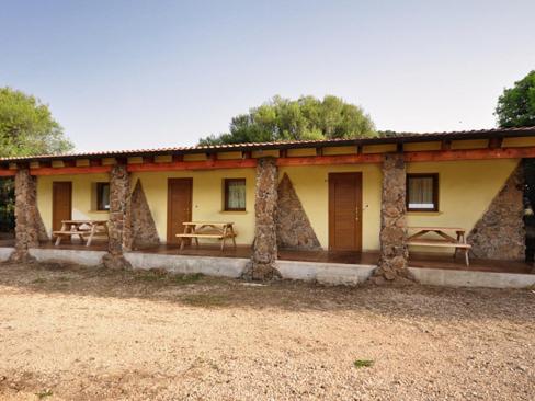 a building with benches in front of it at Agriturismo Didone in Dorgali