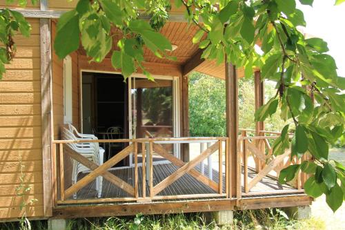 a screened in porch of a house with a door at Les chalets de Dordogne in Razac-dʼEymet