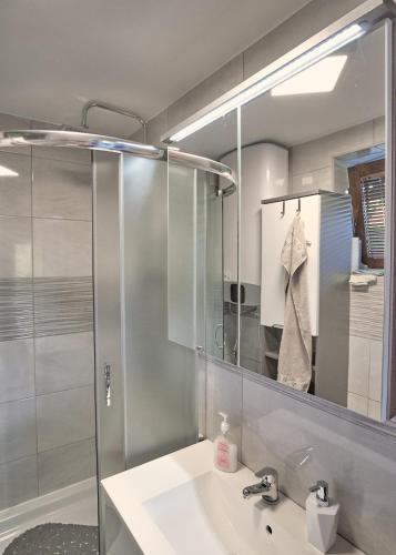 a bathroom with a sink and a shower at Family Retreat with Pool, BBQ & Green Escape by Destination GREEN Croatia in Praporčan