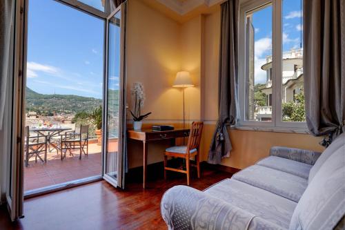 a living room with a couch and a table with a view at Hotel Continental in Santa Margherita Ligure