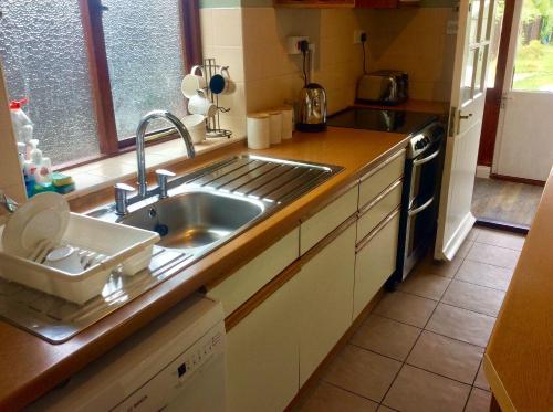 a kitchen with a sink and a counter top at Gateway House in Didcot