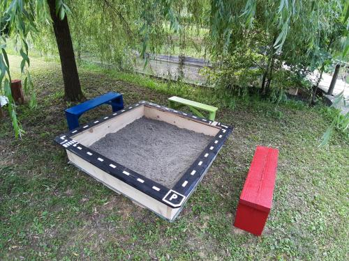 a play area with two chairs and a table at Robinson camp "Zeleni mir" in Josipdol