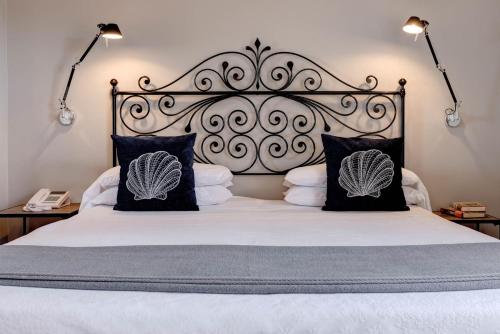 a bed with a white comforter and pillows at Hotel Continental in Santa Margherita Ligure