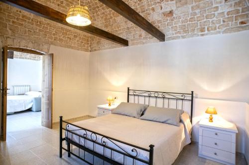 una camera con letto e muro di mattoni di B&B Il Brigante ad Alberobello