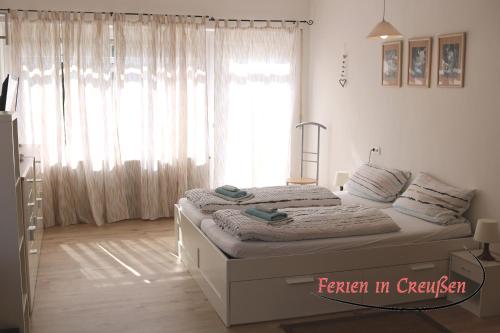 a bedroom with a bed in front of a window at Ferien in Creußen in Creußen