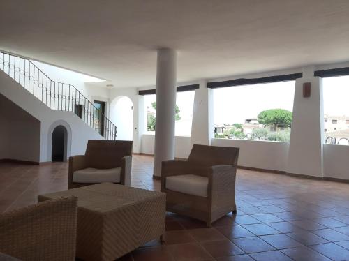a living room with two chairs and a table at Hotel il Faro di Molara in Porto San Paolo