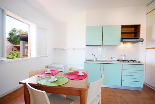a kitchen with a table with two plates on it at Casa Del Golfo in Lacona