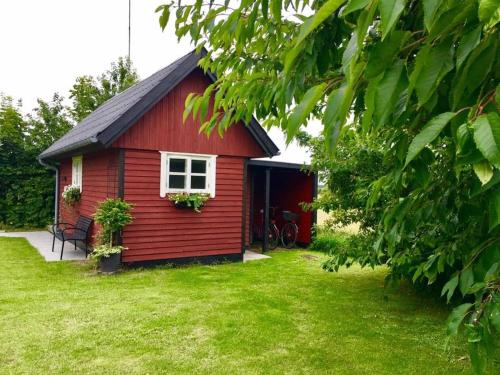 a red and white house with a red roof at Ølholm Cottage in Stege