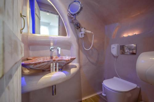 a bathroom with a sink and a toilet at Naxos Island Escape Suites in Plaka