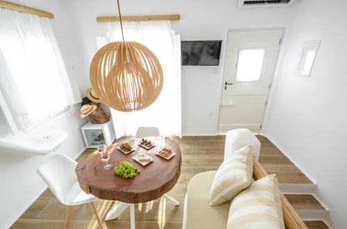 a living room with a table and a couch at Naxos Island Escape Suites in Plaka
