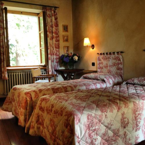 a bedroom with a large bed and a window at Le 5 Frecce in Cavour
