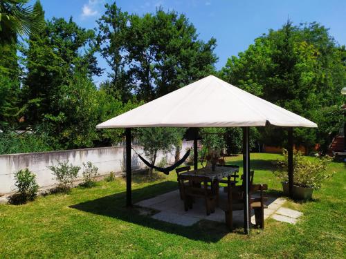 a table and chairs under a tent in a yard at Casa L'Osservanza in Cesena