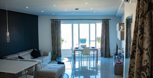 a living room with a couch and a table at Couple's Getaway in Is-Swieqi