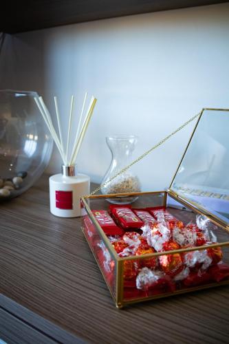a table with a box of chocolates and a vase at Couple's Getaway in Is-Swieqi