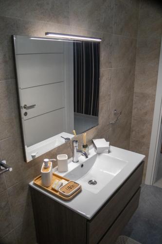 a bathroom with a sink and a mirror at Couple's Getaway in Is-Swieqi