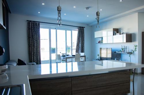 a kitchen with a large white island in a room at Couple's Getaway in Is-Swieqi