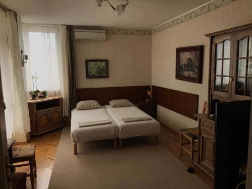 a bedroom with a bed and a television in it at Апартамент Вангелов in Nesebar
