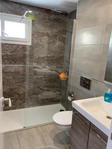a bathroom with a shower and a toilet and a sink at Villa Bahia calpe in Calpe