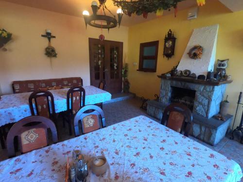 a living room with two beds and a fireplace at Ośrodek Wczasowy Wierchy in Korbielów