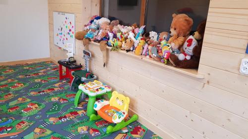a bunch of stuffed animals sitting on a shelf at Antonówka in Trybsz