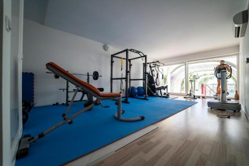 a gym with several tread machines in a room at Apartments Barbati in Novalja