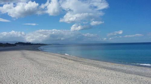 a beach with a blue sky and the ocean at Il Borgo & il Feudo in Badolato