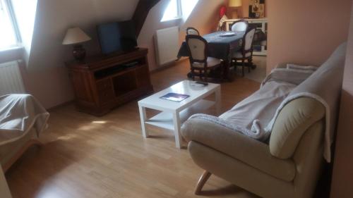 a living room with a couch and a table at Gîte Yves in Wihr-au-Val