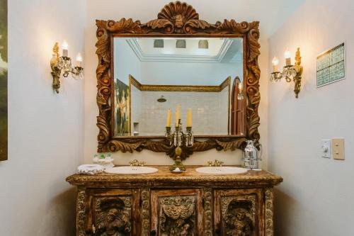 a bathroom with a mirror and a sink at Hacienda San Angel in Puerto Vallarta
