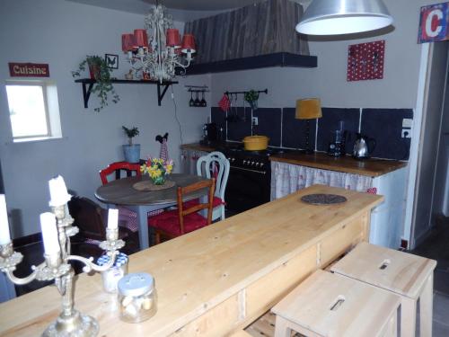 a kitchen with a wooden table and a dining room at Gîte des petites Poules rousses 9 personnes Zoo Parc Beauval Saint Aignan et Châteaux de la Loire in Choussy
