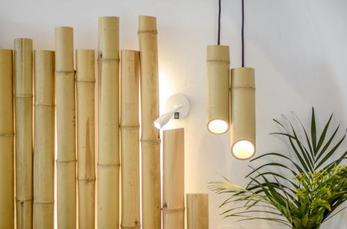 a group of bamboo sticks hanging from a wall at Naxos Island Escape Suites in Plaka