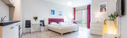 a bedroom with a bed in a room with a kitchen at Sopot Residence - Sea Deluxe apartment A in Sopot