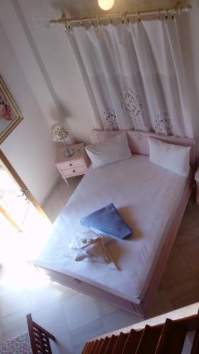 
a bed that has a pillow on it at Zacharoula Rooms in Manganítis
