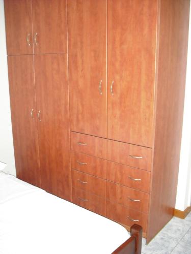 a large wooden cabinet with drawers in a room at ΣΑΡΑΝΤΗΣ ΜΑΡΚΌΠΟΥΛΟς in Lakithra