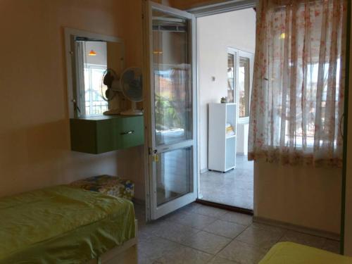 a room with a door to a kitchen with a refrigerator at Kapka Apartments in Kiten