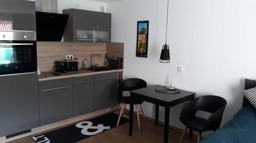 a kitchen with a sink and a table in a room at Businessappartement Nr 2 in Worms