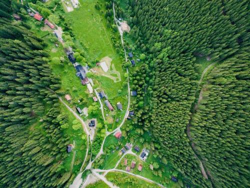 an aerial view of a field with trees and a road at Chata Magurka in Partizánska ľupča