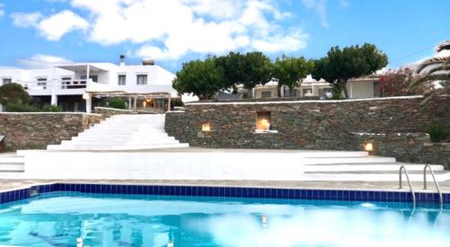 a swimming pool in front of a house at Cape Napos in Faros