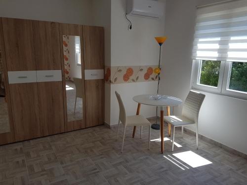 a dining room with a table and chairs and a door at Bestie House in Kotor